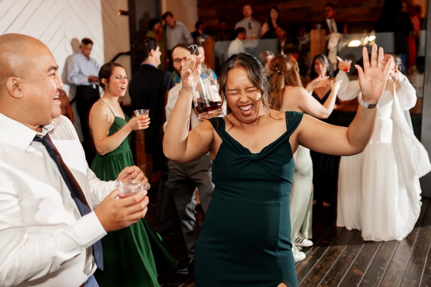 At a lively indoor celebration at Union/Pine, people danced and smiled, holding their drinks in a vibrant, joyful atmosphere reminiscent of a wedding day celebration.