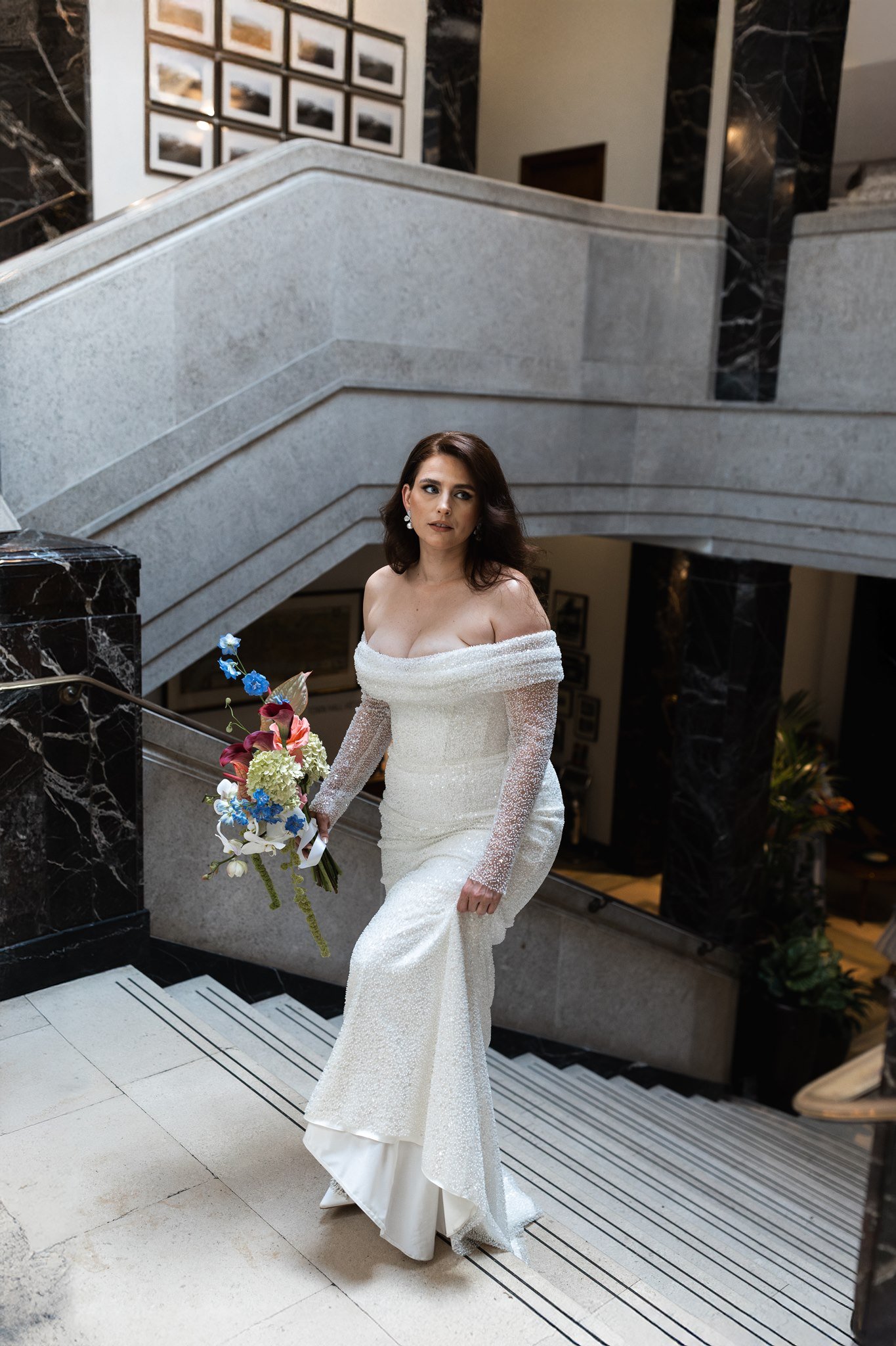 east london bride in eva lendel aretta dress having photography for her wedding shoot on the steps of bethnal green town hall london