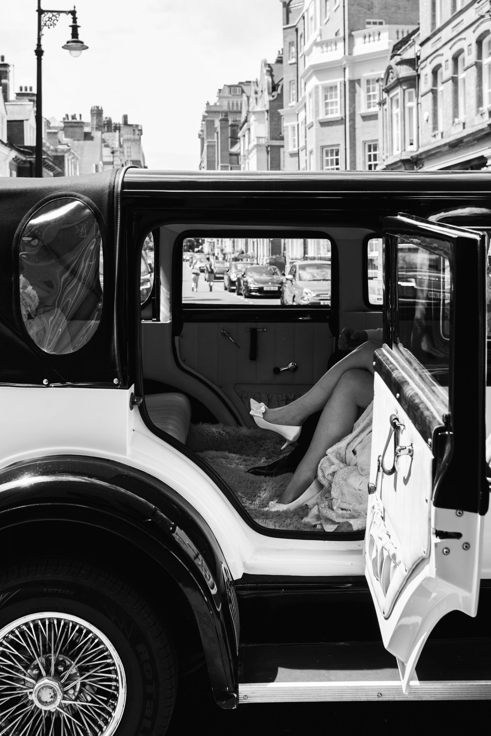 marlyebone wedding photography in vintage car - brides heels poking out