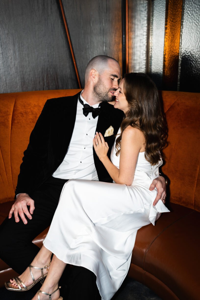 east london newlywed couple kiss in direct flash photography at their evening reception at Savage Garden Rooftop bar in London