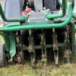Lawn aerator machine used for soil aeration and lawn health enhancement.