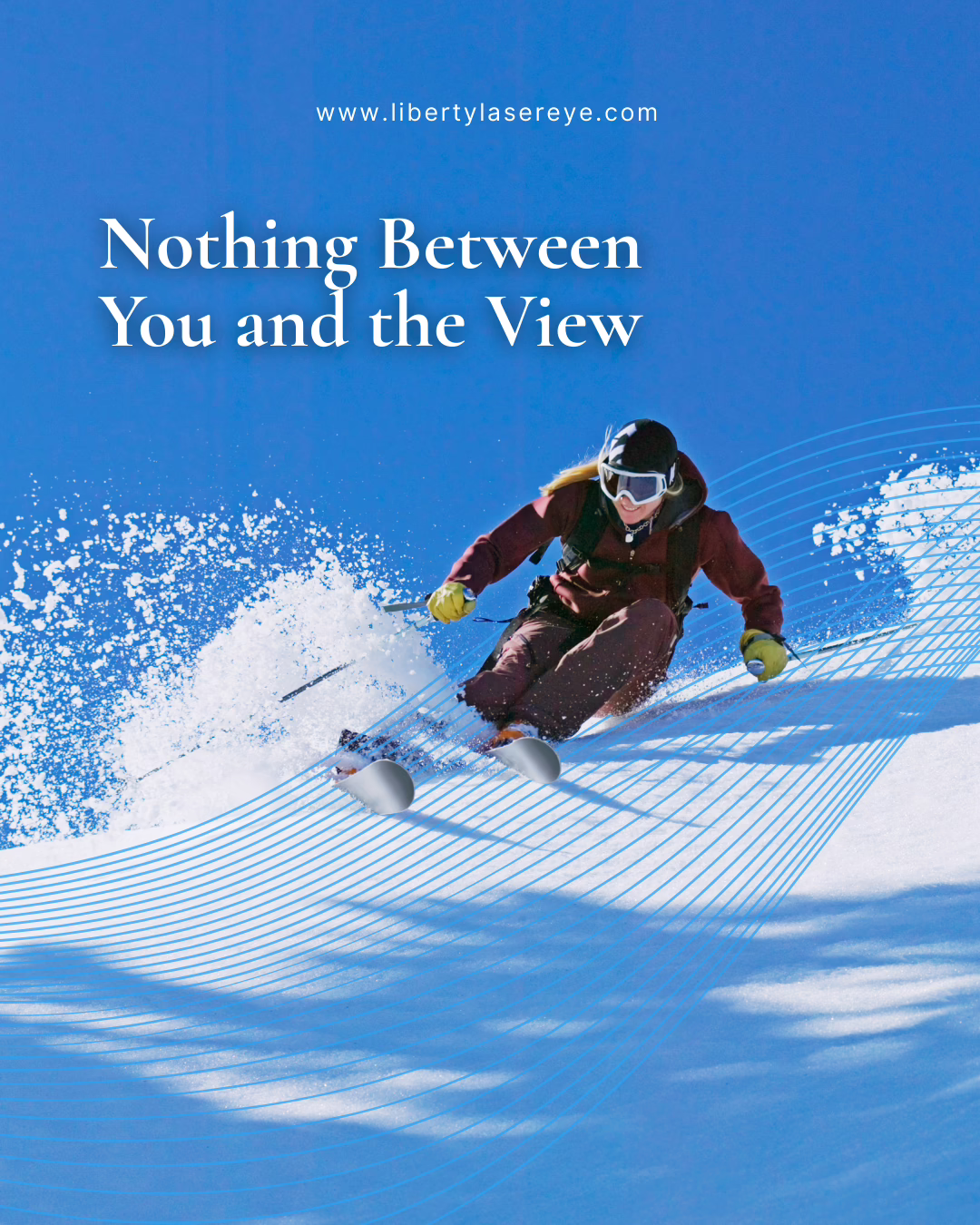 Skier carving down a snowy slope under a clear blue sky