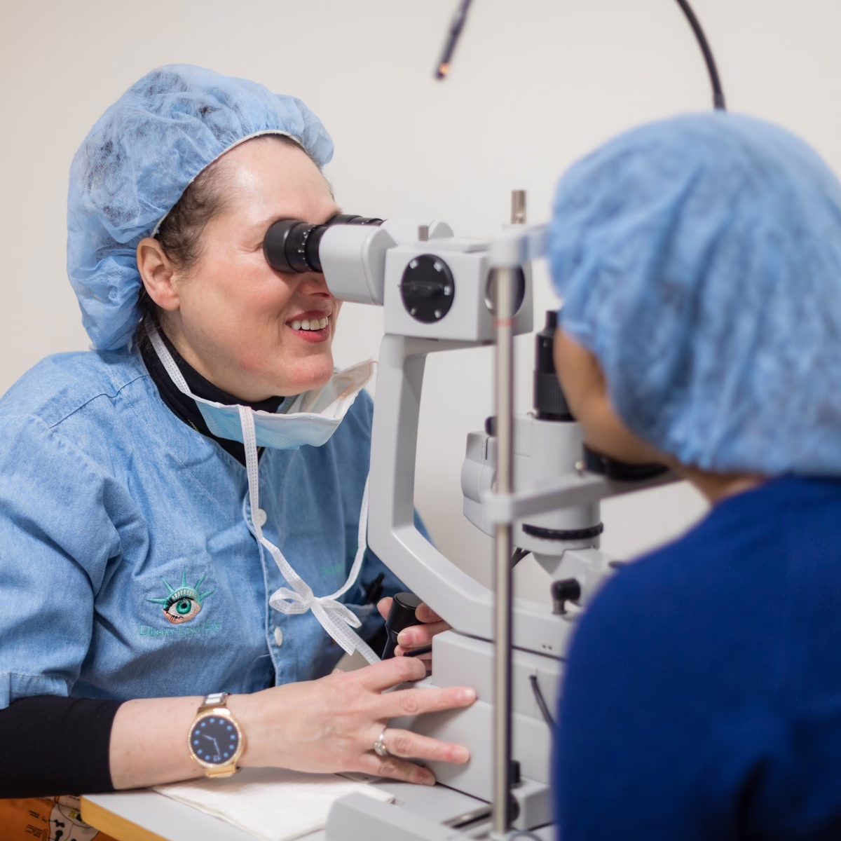 Eye doctor examining a patient's eye with a slit lamp microscope