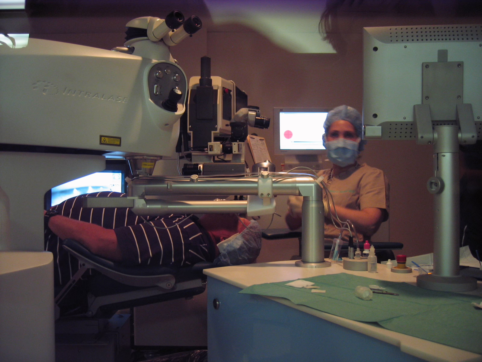 Patient undergoing eye surgery with a surgeon present