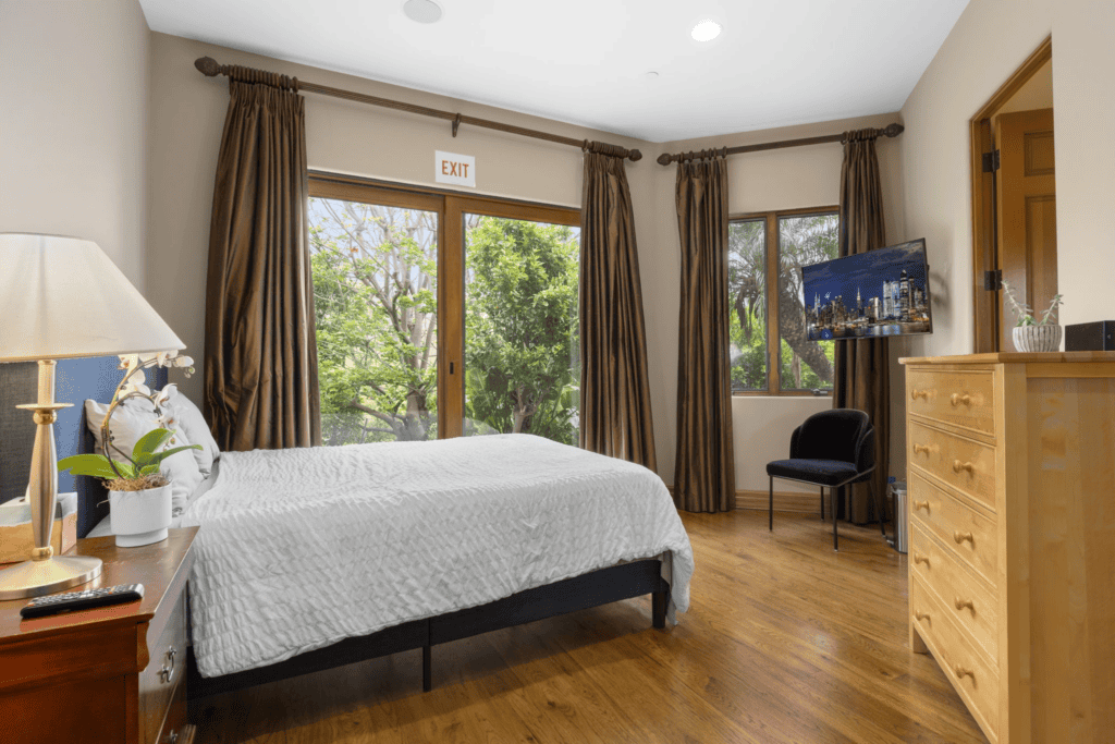 View of a bedroom with big window and lots of natural light in our residential treatment center