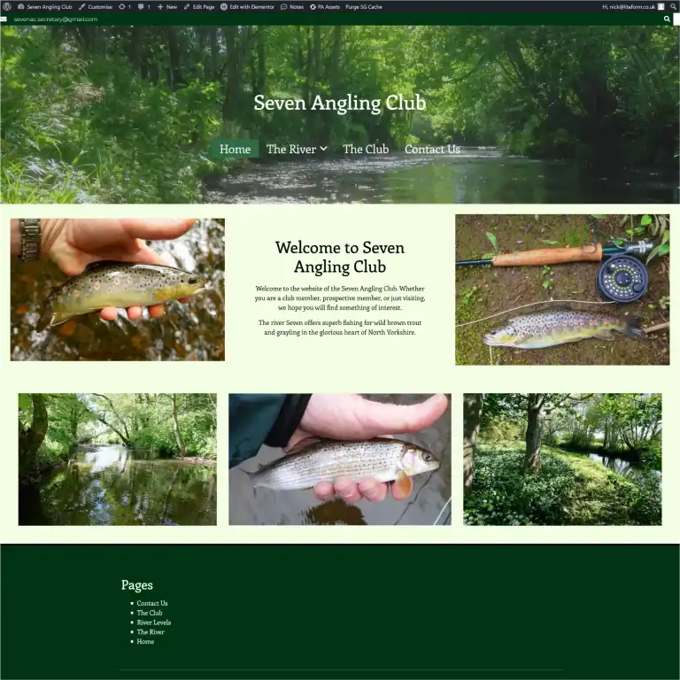 Angler holding a fish with a river background, fishing gear nearby.