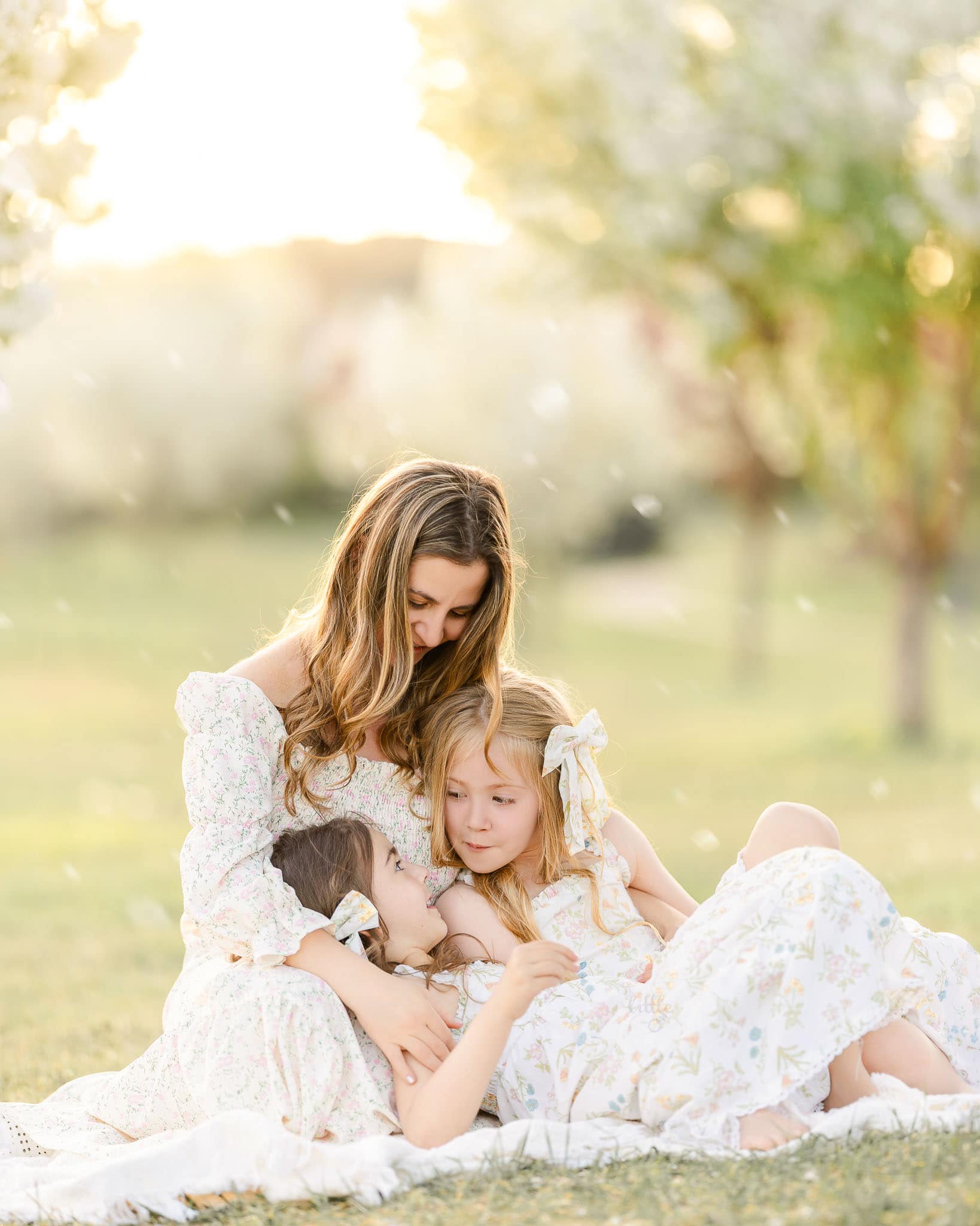 Mom hold her 2 girls for family photoshoot in Edmonton during spring