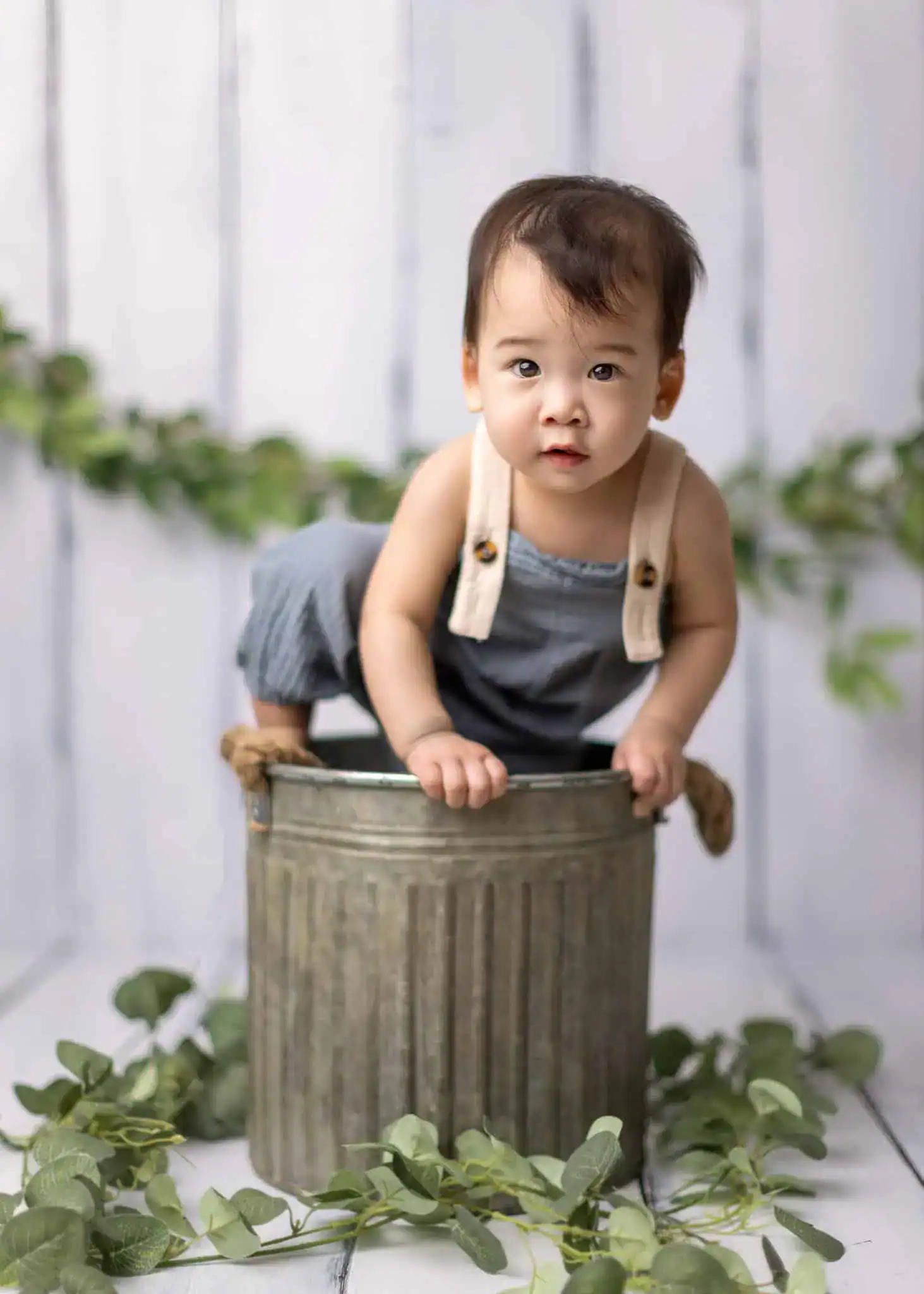 1 year old baby standing in basket and trying to run away