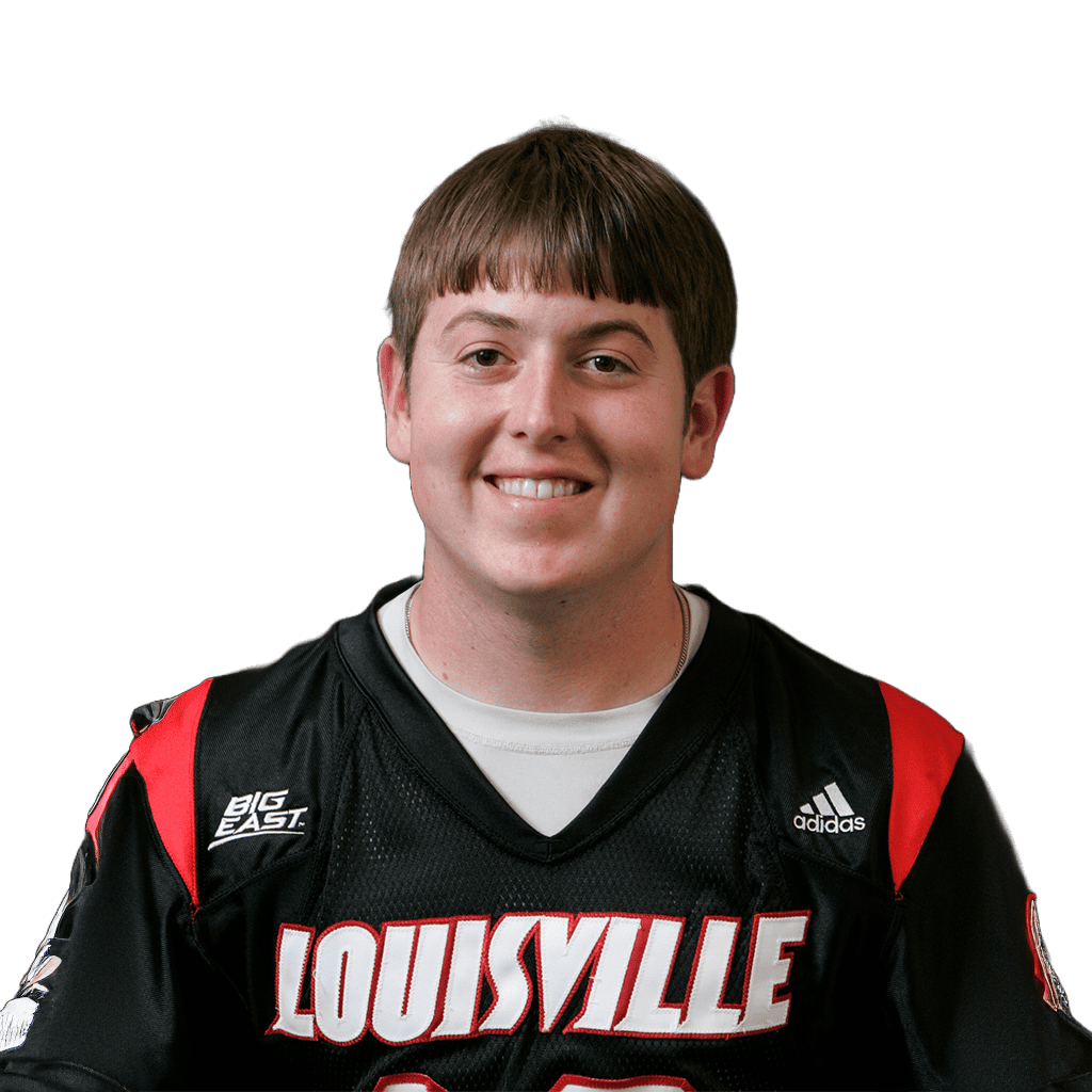 Young football player wearing Louisville jersey smiling for the camera.