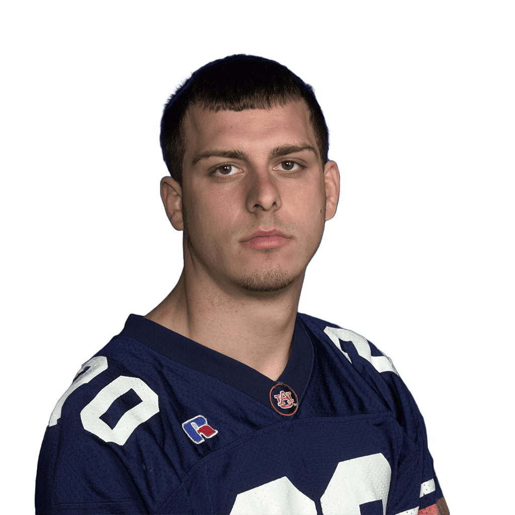 Football player in blue jersey with number 10, facing forward, serious expression.