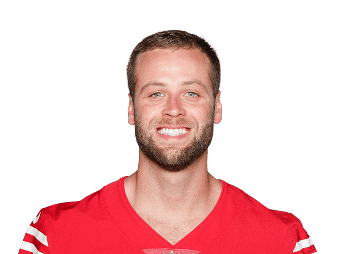 Football player in red jersey smiling for the Lou Groza Award photo.