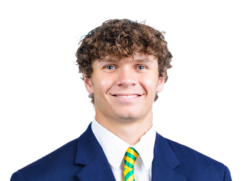 Young man in a suit smiling, representing Lou Groza Award nominee or winner.