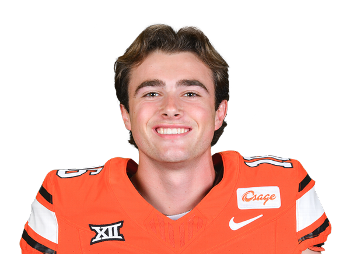 Young male football player in orange uniform smiling for the camera.