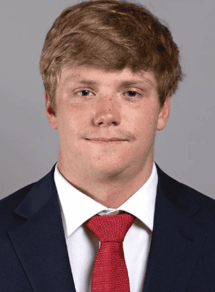 Young male football kicker in formal suit and red tie for Lou Groza Award.