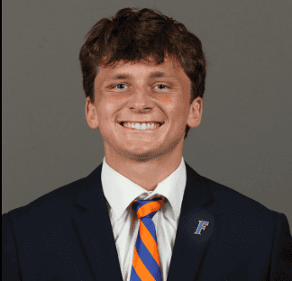 Young man in suit smiling, representing Lou Groza Award nominee.