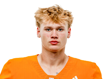 Young football player in orange uniform on field for Lou Groza Award.