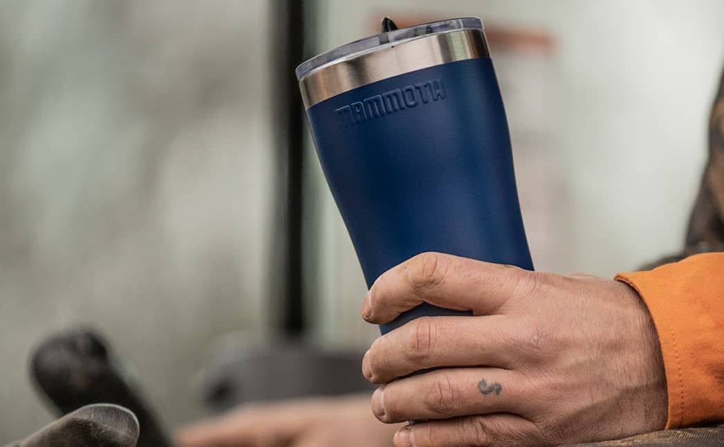 Slide-3---20oz-Rover-min person holding blue 20 ounce rover tumbler