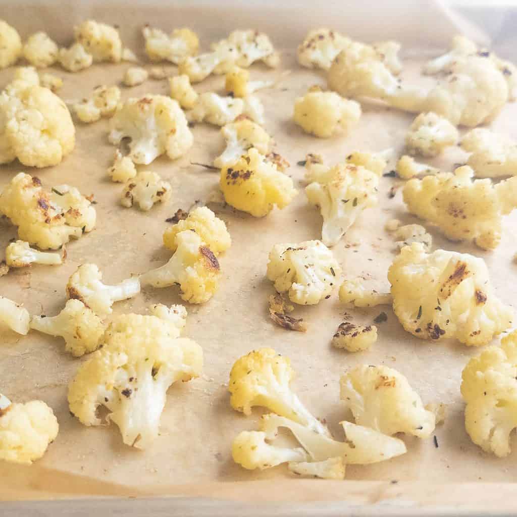 Roasted cauliflower on sheet pan with parchment paper