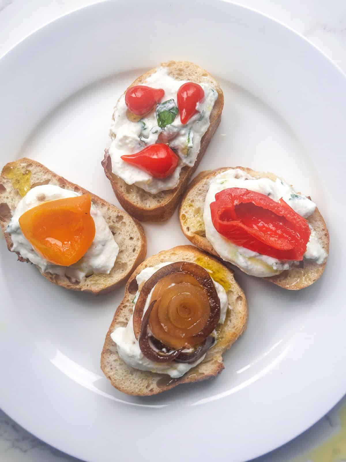 Whipped ricotta crostini with pickled veggie antipasti.