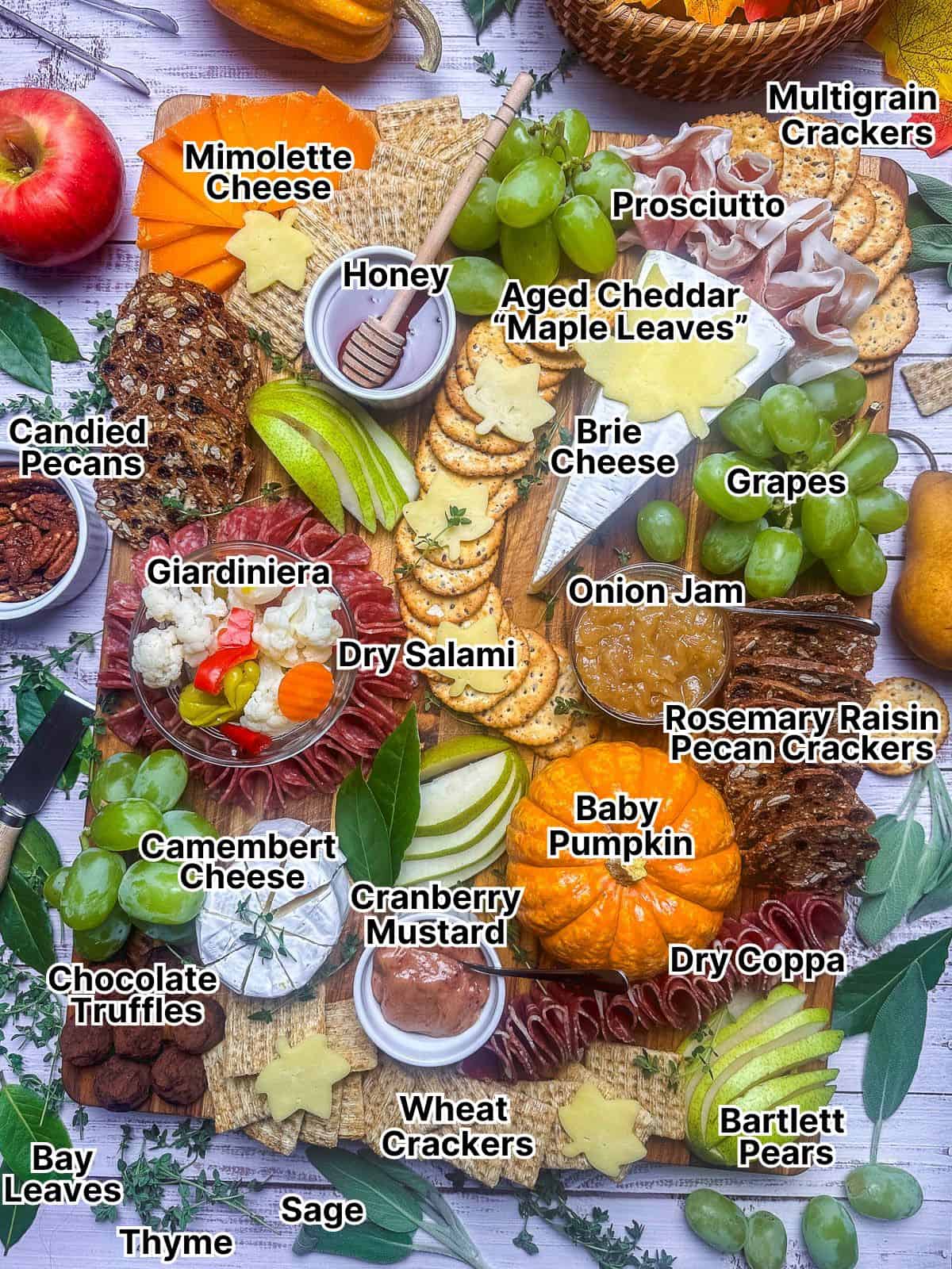 Fall themed charcuterie board with labeled ingredients.