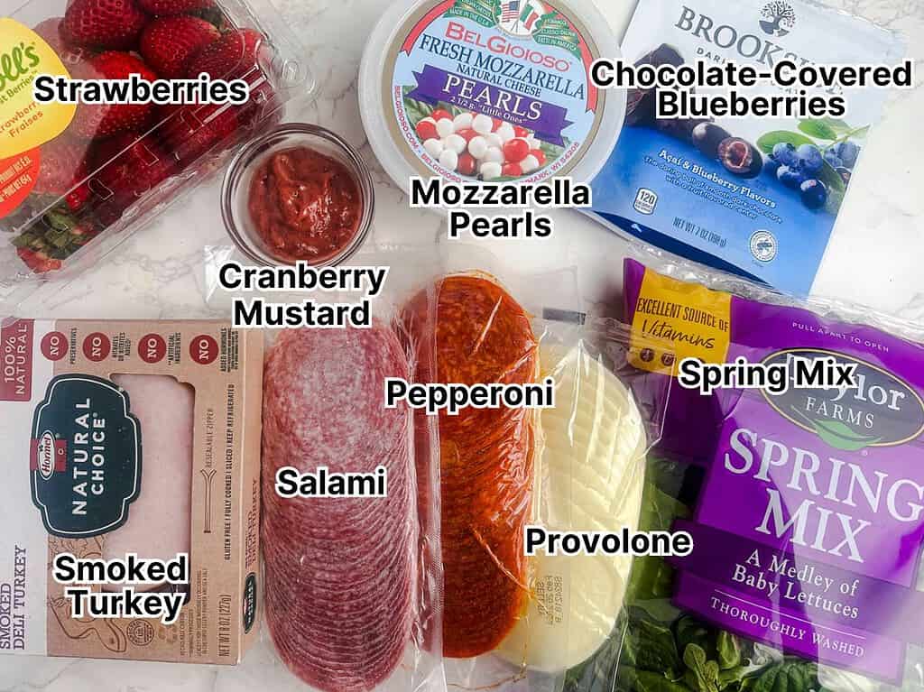 Ingredients for the charcuterie bouquet displayed on a counter top.