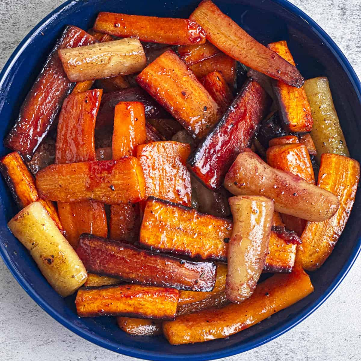 Hot honey butter glazed carrots in a blue bowl