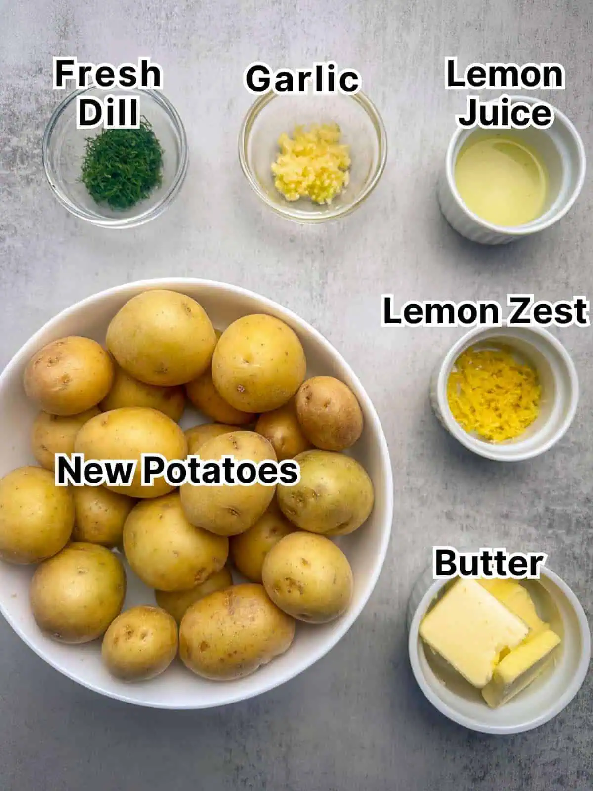 New potatoes, butter, lemon zest, lemon juice, garlic, and dill in small bowls.