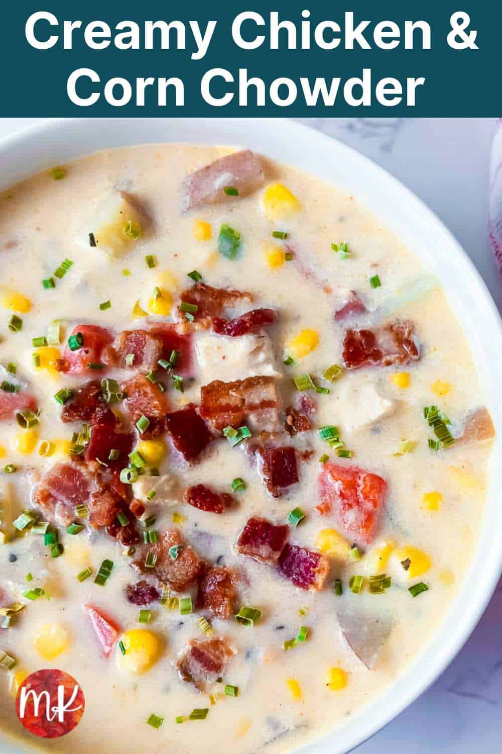 Creamy chicken corn chowder in a bowl with crumbled bacon and chives on top with the title of the recipe at the top.