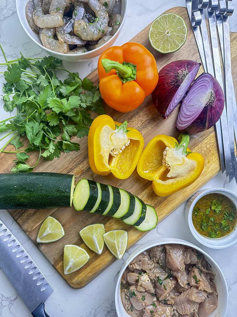 Recipe ingredients including shrimp, chicken, limes wedges, cilantro among others.