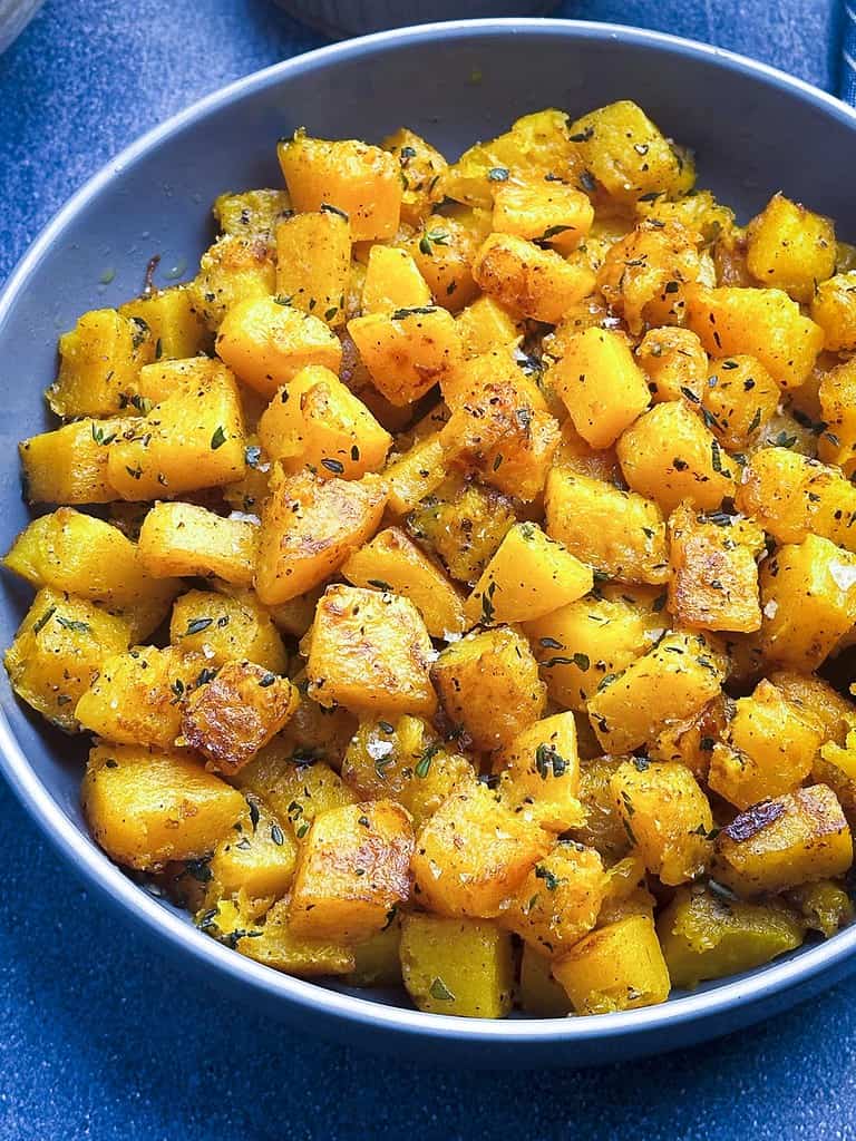 Close up shot of sauteed butternut squash in a bowl.