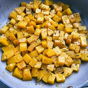 Glazed butternut squash in a skillet.