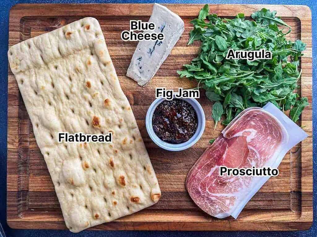 Ingredient shot with flatbread, fig jam, prosciutto, blue cheese and arugula.