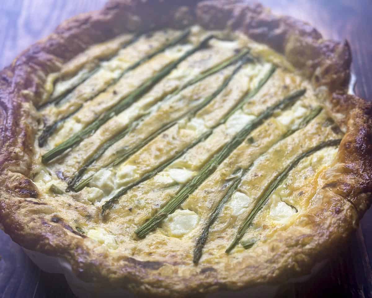 Asparagus ricotta tart with puff pastry crust close up.
