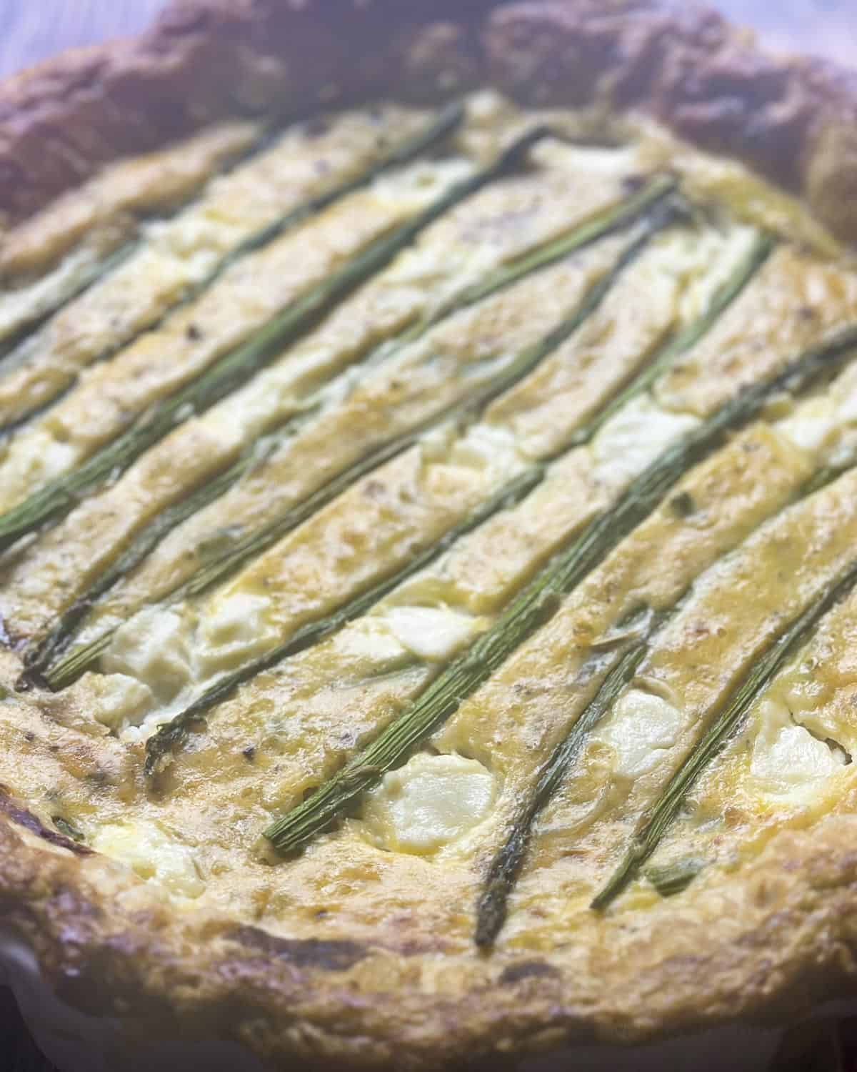 Asparagus and ricotta tart with puff pastry crust close up.