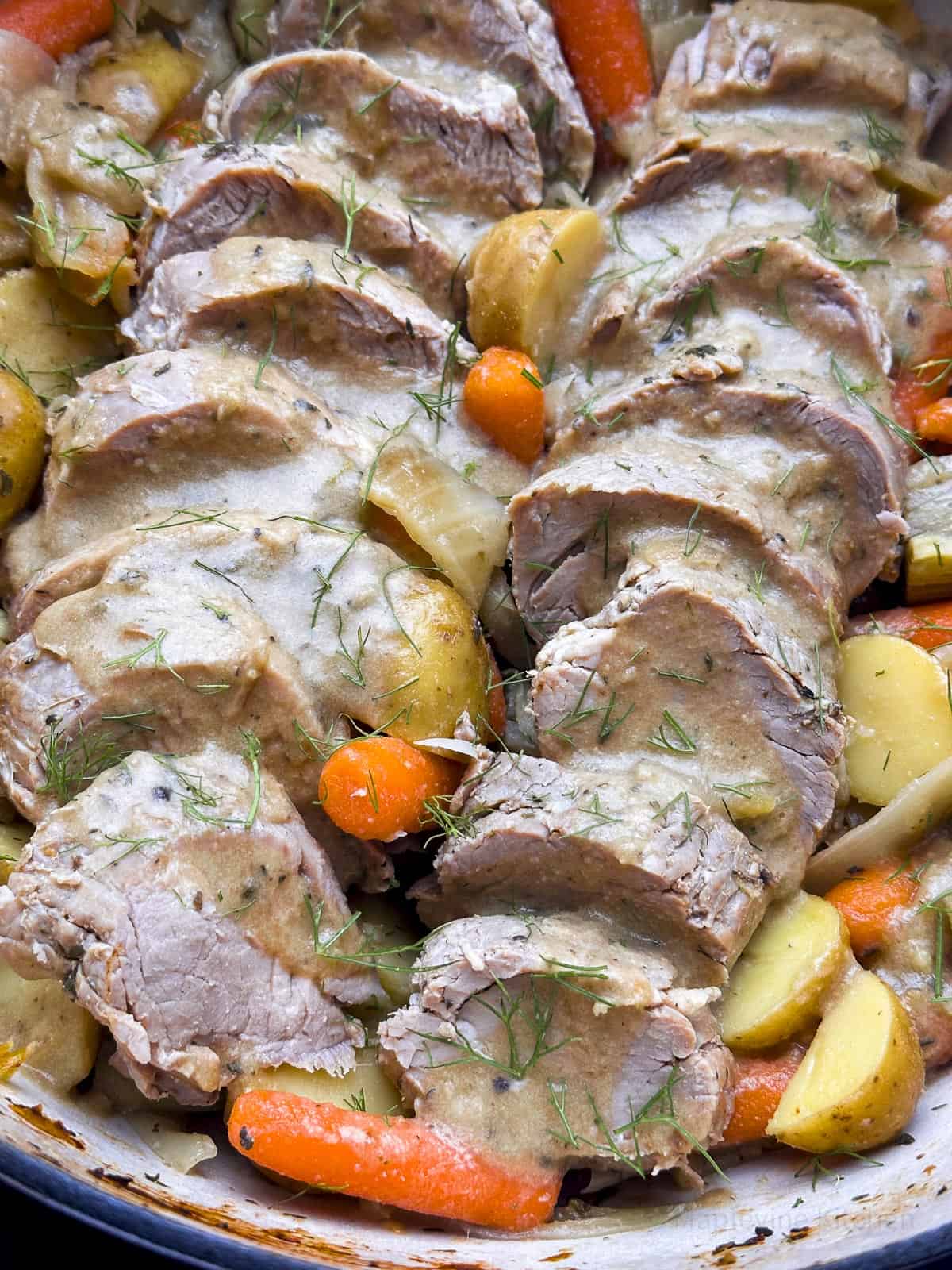 Dutch oven pork tenderloin with vegetables and gravy.
