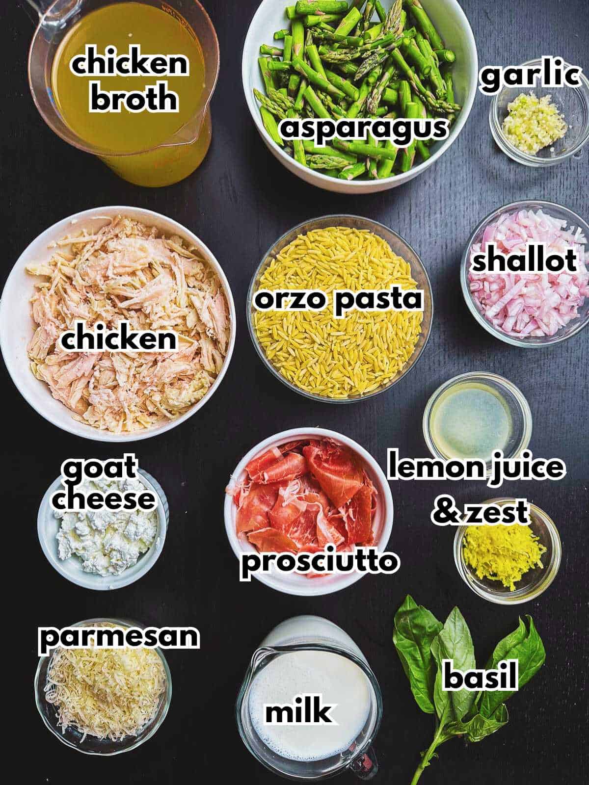 Creamy chicken orzo bake recipe ingredients spread out on a dark tabletop.