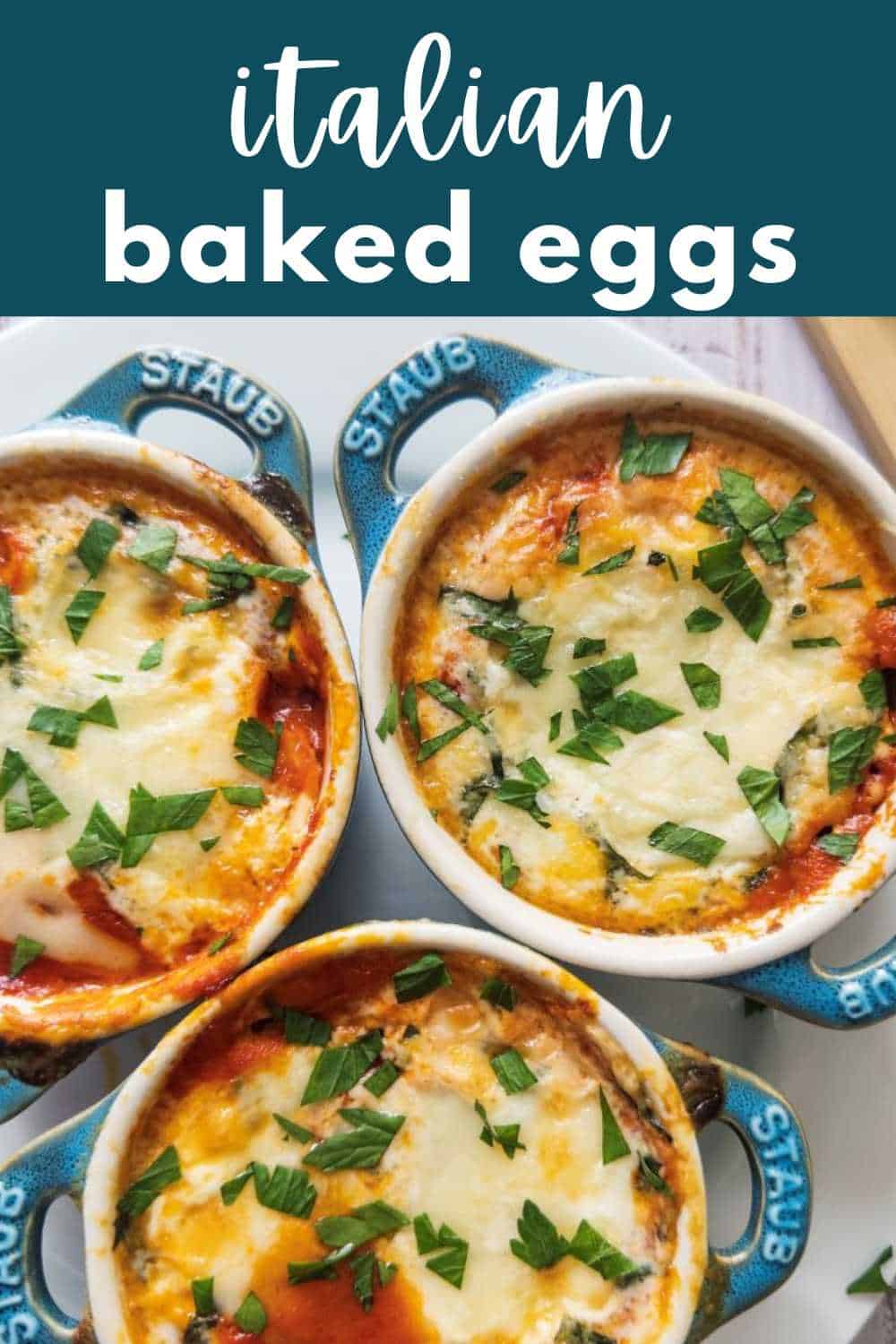 Italian baked eggs in Staub mini cocotte dishes with parsley sprinkled on top.