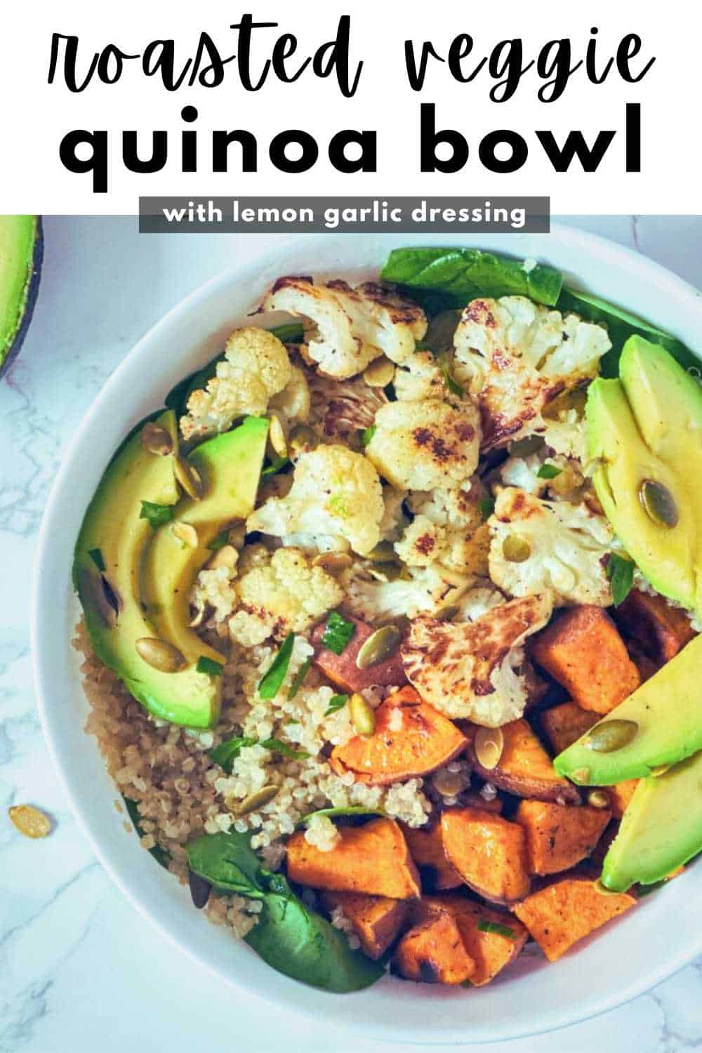 Roasted cauliflower and sweet potato in a bowl with quinoa, spinach and avocado.