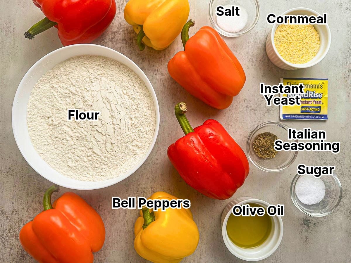 Colorful bell peppers with flour, salt, yeast, and seasonings for cooking.