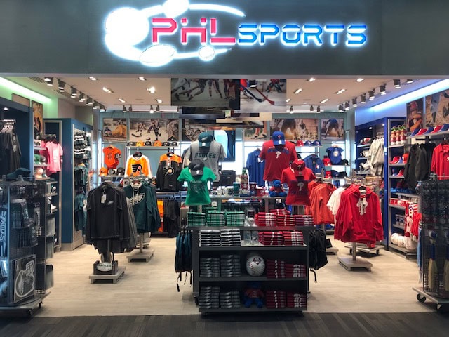 Sports apparel and merchandise display inside a PXL Sports store.