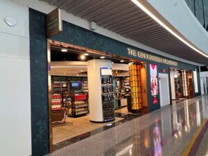 The Concourse Coffee shop in a modern shopping mall with seating and display cases.