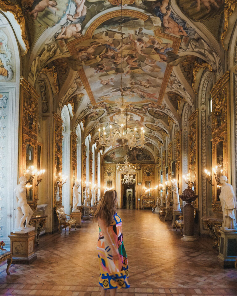 This hidden gem of a museum called Galleria Doria Pampilj and this hall reminded me a bit of the Hall of Mirrors at Versailles. Instead of mirrors lining both sides of the long corridor, there are floor to ceiling windows. There are candelabras in between each window to give the effect of mirrors. The ornate frescos or paintings along the ceiling include the archways around the windows. There are also sculptures lining the hall, and everything is covered in ornate gold decor that makes this such a beautiful museum to visit in Rome, and you'll avoid the crowds!