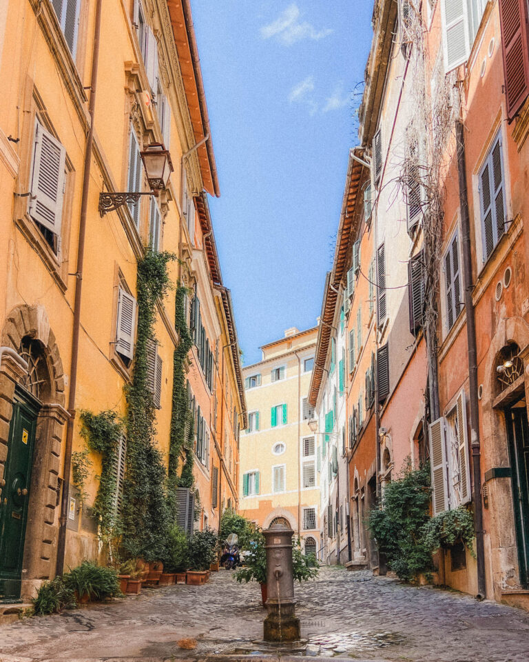 This is one of the quaint neighborhoods in Rome near the Colosseum that my husband and I stumbled upon when trying to get lost one afternoon. This neighborhood had plenty of narrow, cobblestone walkways with four story buildings on either side in the traditional Roman hues of yellow, orange, and brown. The shutters are a mix of brown and colorful greens and blues. There was also a small, ancient looking fountain right in the middle of the pedestrian walkway, you will actually find the water from the fountains is Rome is drinkable!
