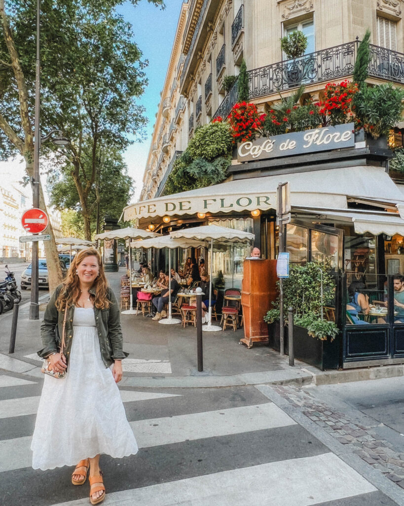 When planning your Paris in three days itinerary it's essential to visit a traditional Parisian cafe like this one. This cafe is called Cafe de Flore and it's been made very popular on Instagram, and for good reason. You can see this cafe protrudes from the traditional Parisian facades with floral and foliage hanging down the entrance way. The cream awnings cover the large amount of two person tables crowding and spilling into the sidewalk.