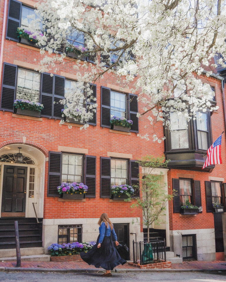 This is typical Bostonian architecture you will find in Beacon Hill, Back Bay, and other neighborhoods in Boston. These three to four story brownstones are adorned by black shutters, and the doors entryways are curved. They also sometimes have intricate windows protruding from the facades that makes it look more upscale. Many of the beautiful brownstones in Beacon Hill will have flowers adorning their window boxes and American flags hanging out front. Many of the streets are also lined with various types of trees that some create a canopy on the street and are stunning in the spring when they bloom.