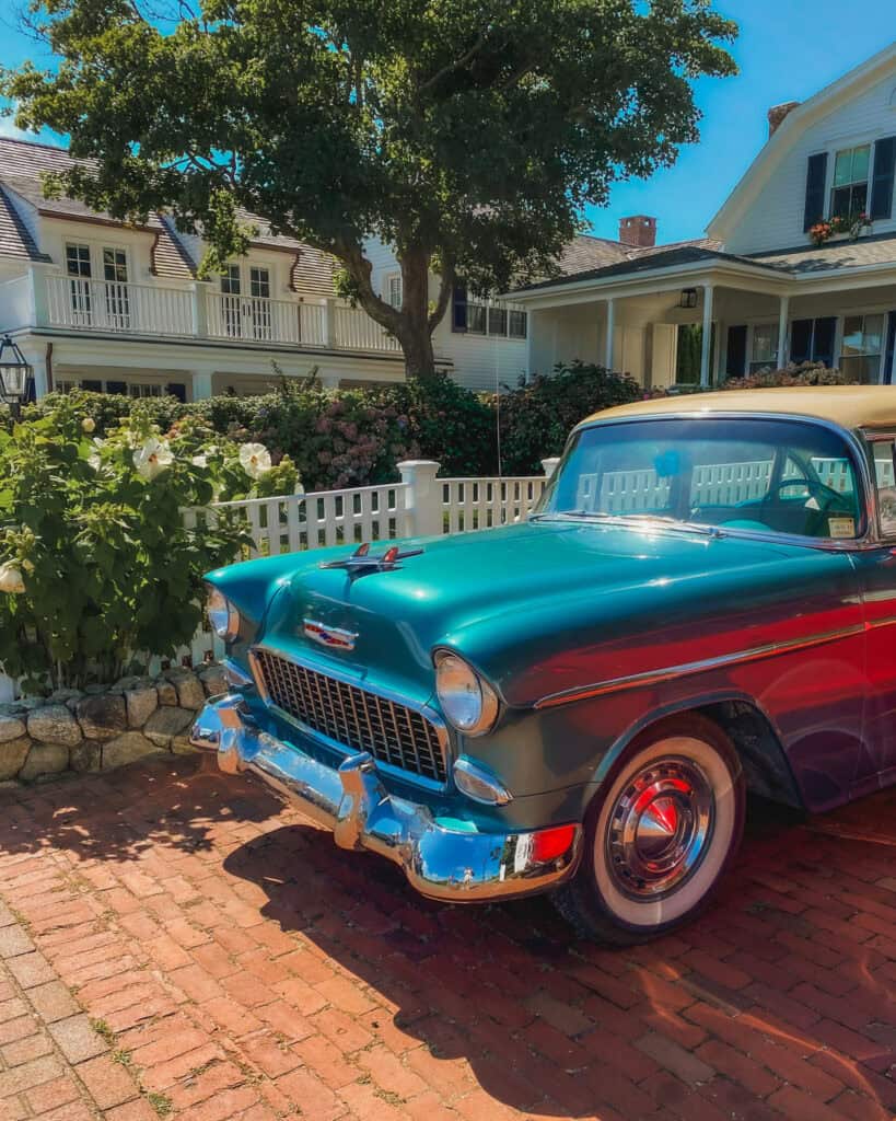 This is one of the residential neighborhoods in Edgartown on Martha's Vineyard. Many of these houses are white washed with blue shingles, and adorning flower pots in the windows. This one even has a vintage turquoise car parked right in the driveway. Edgartown is one of the most beautiful places on Martha's Vineyard.