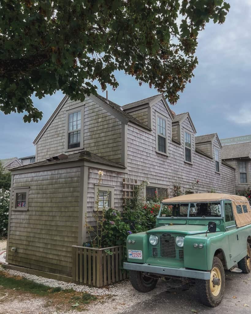 This is another gray shingled Cape Cod style home in the village of Sconset, Nantucket. It has a vintage-esque Jeep parked out front, which are very popular vehicles to have on this island!