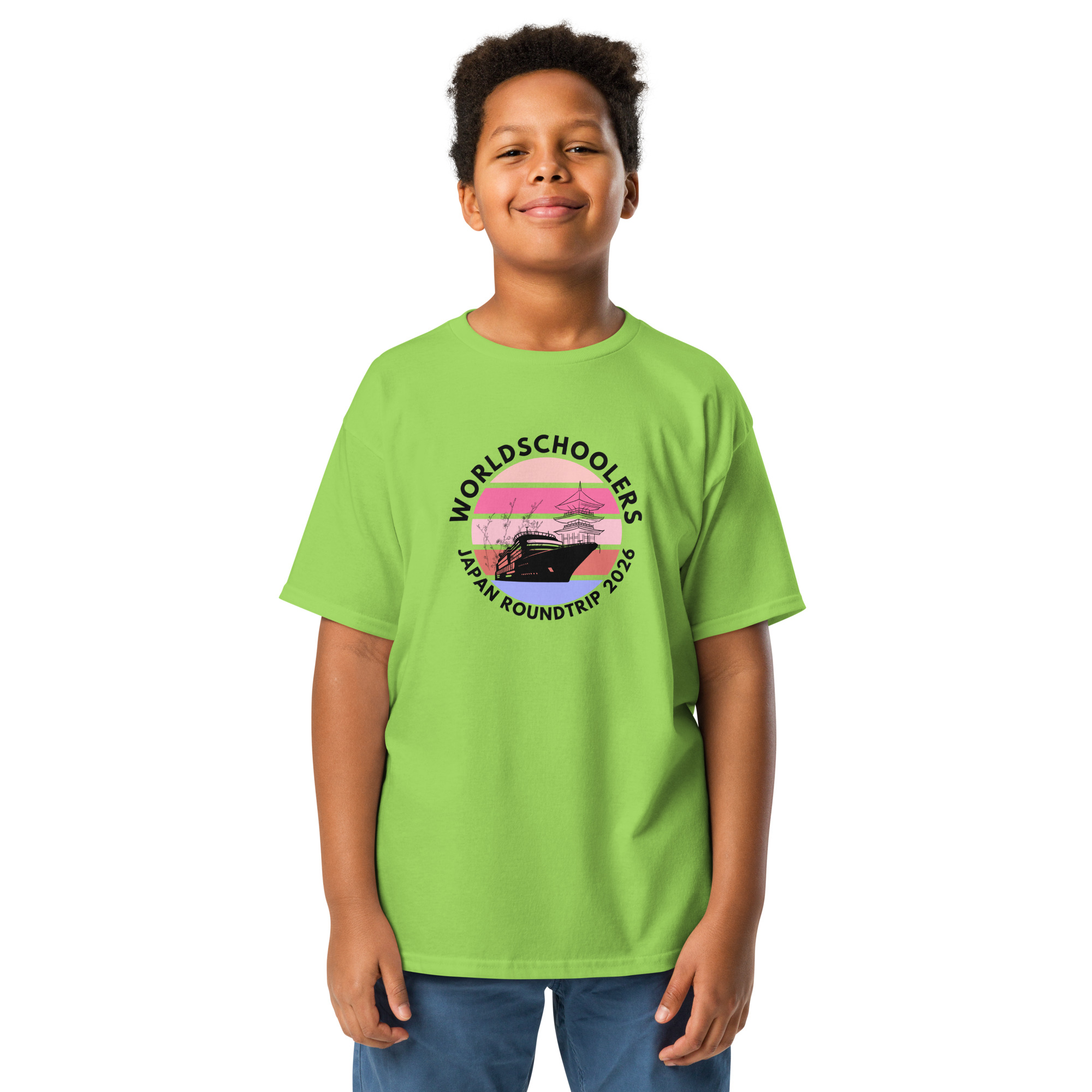 Child wearing a bright green Japan Roundtrip 2026 youth graphic tee with a scenic design, perfect for travel-themed fashion and casual wear.