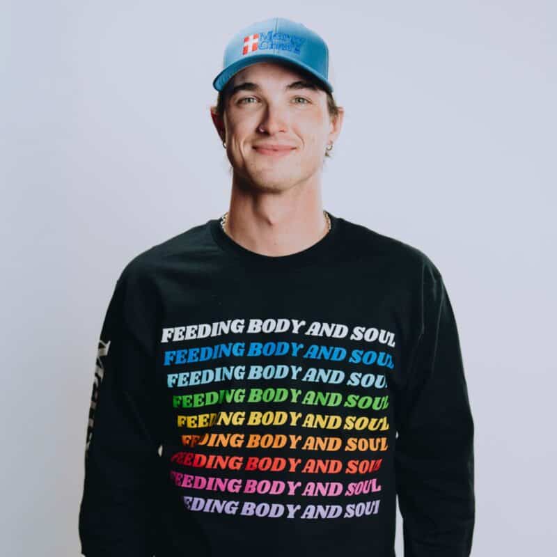A front view of Mercy Chefs' black Feeding Body and Soul long sleeve