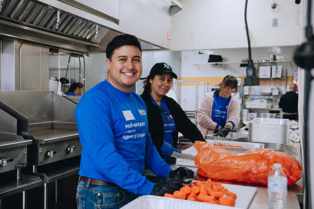 Volunteers chopping fresh vegetables to prepare meals for California wildfire victims.